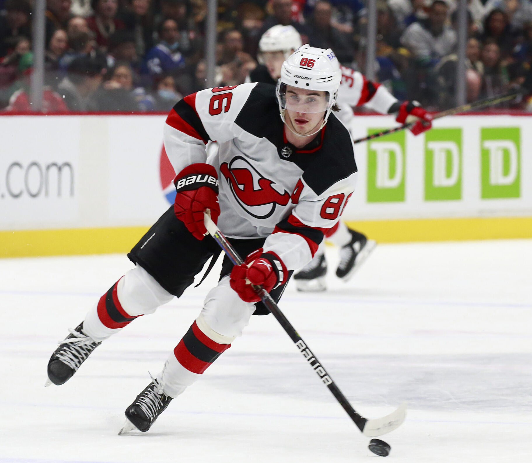 Jack Hughes #86 of the New Jersey Devils skates up ice during their NHL game against the Vancouver Canucks