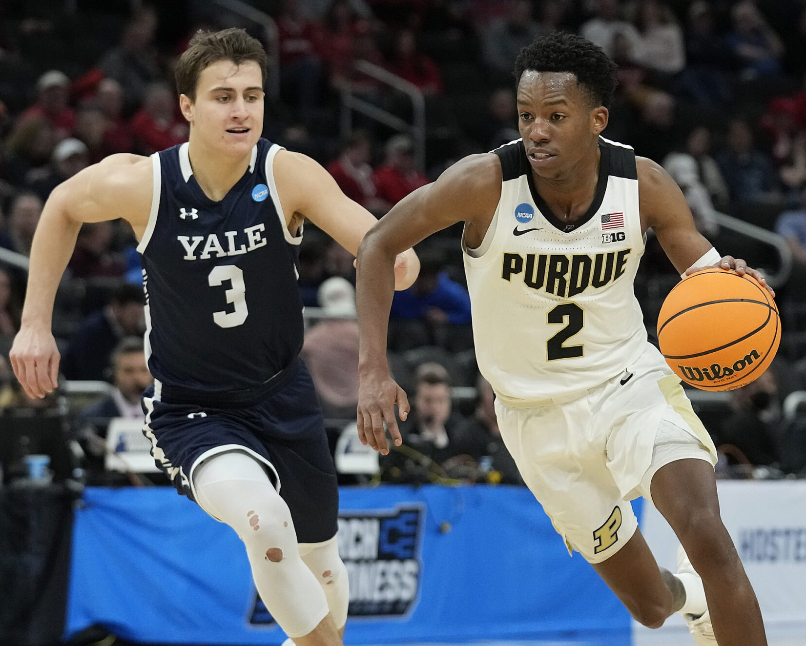 Eric Hunter Jr. #2 of the Purdue Boilermakers dribbles the ball as August Mahoney #3 of the Yale Bulldogs rushes to defend in the first half of the game during the first round of the 2022 NCAA Men's Basketball Tournament at Fiserv Forum on March 18, 2022