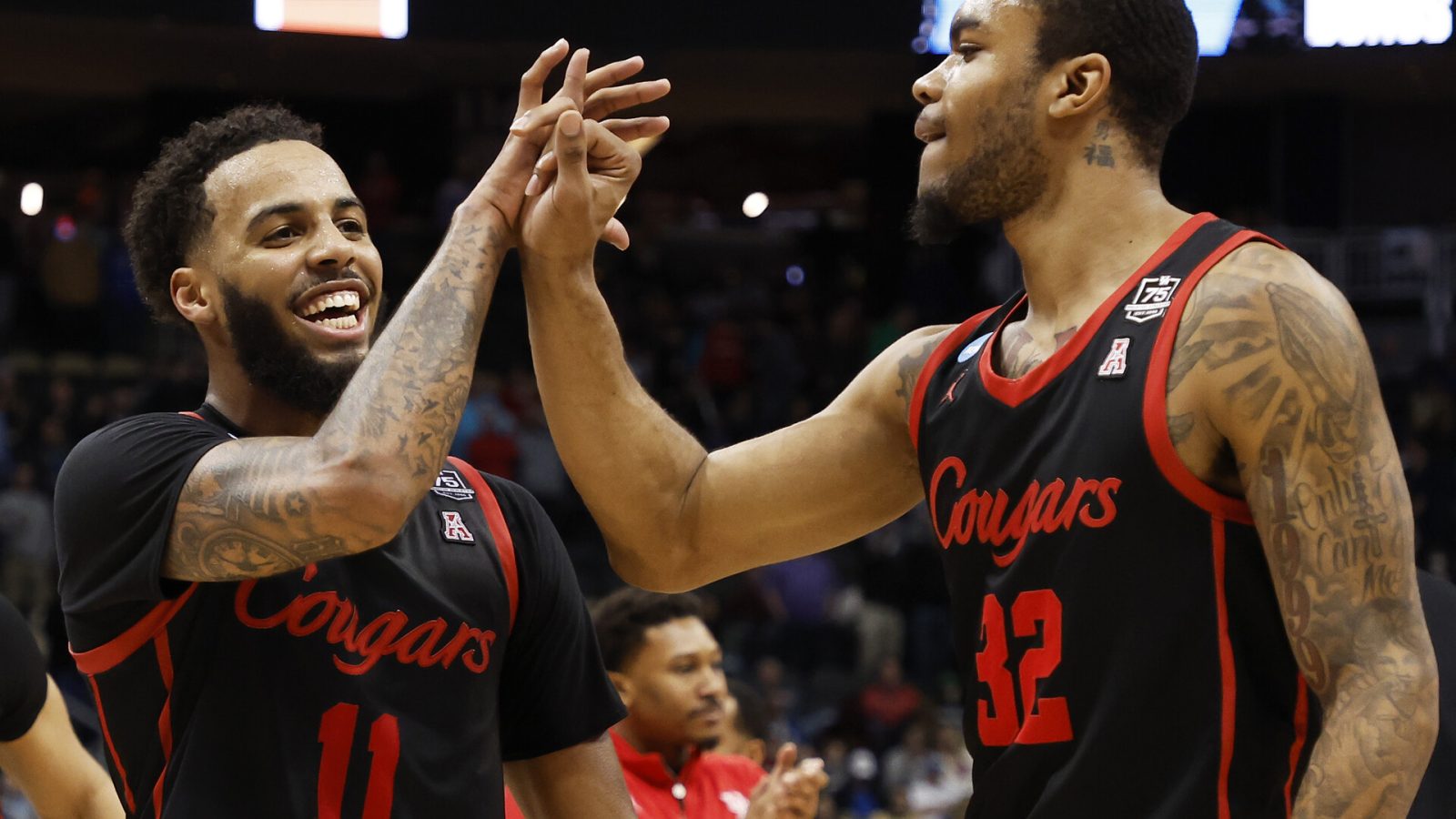 Kyler Edwards #11 and Reggie Chaney #32 of the Houston Cougars celebrate after defeating the Illinois Fighting Illini 68-53 during the second round of the 2022 NCAA Men's Basketball Tournament at PPG PAINTS Arena on March 20, 2022 in Pittsburgh, Pennsylvania.
