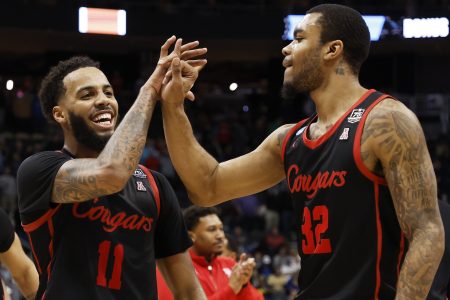 Kyler Edwards #11 and Reggie Chaney #32 of the Houston Cougars celebrate after defeating the Illinois Fighting Illini 68-53 during the second round of the 2022 NCAA Men's Basketball Tournament at PPG PAINTS Arena on March 20, 2022 in Pittsburgh, Pennsylvania.