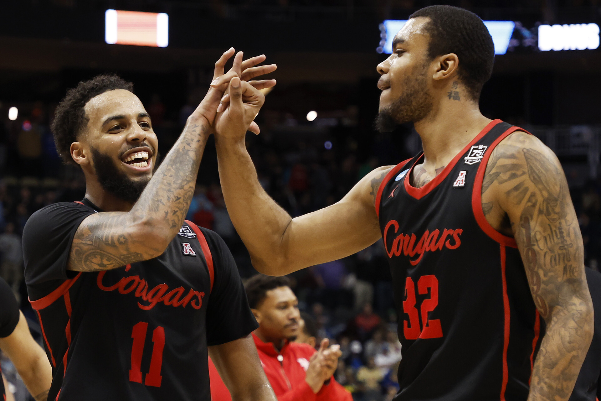 Kyler Edwards #11 and Reggie Chaney #32 of the Houston Cougars celebrate after defeating the Illinois Fighting Illini 68-53 during the second round of the 2022 NCAA Men's Basketball Tournament at PPG PAINTS Arena on March 20, 2022 in Pittsburgh, Pennsylvania.