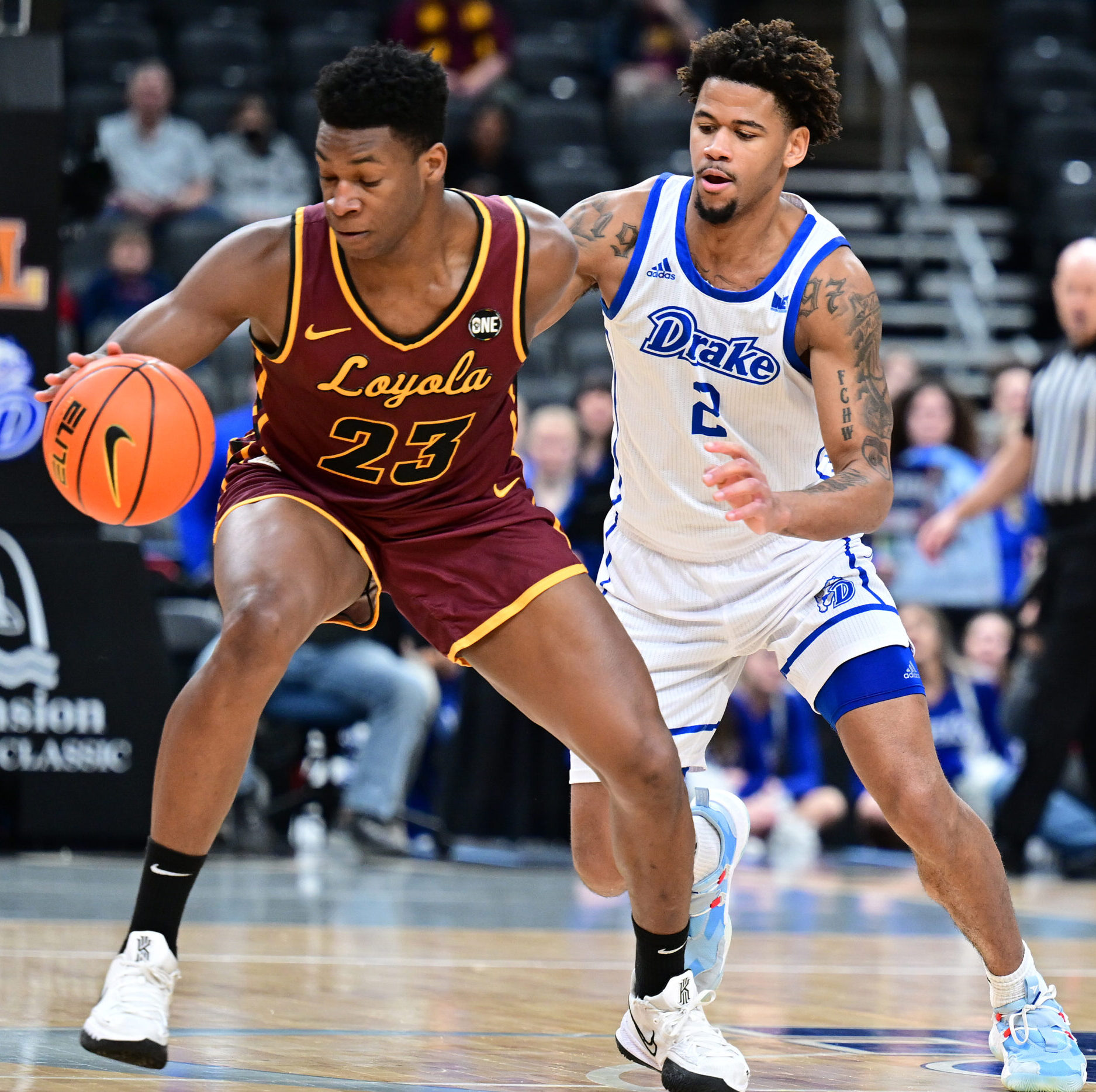 Loyola Chicago Ramblers forward Chris Knight (23) with the ball while guarded by Drake Bulldogs forward Tremell Murphy (2) during the championship game of the Missouri Valley Conference between the Loyola Chicago Ramblers and the Drake Bulldogs on March 06, 2022, at Enterprise Center, St. Louis , MO.