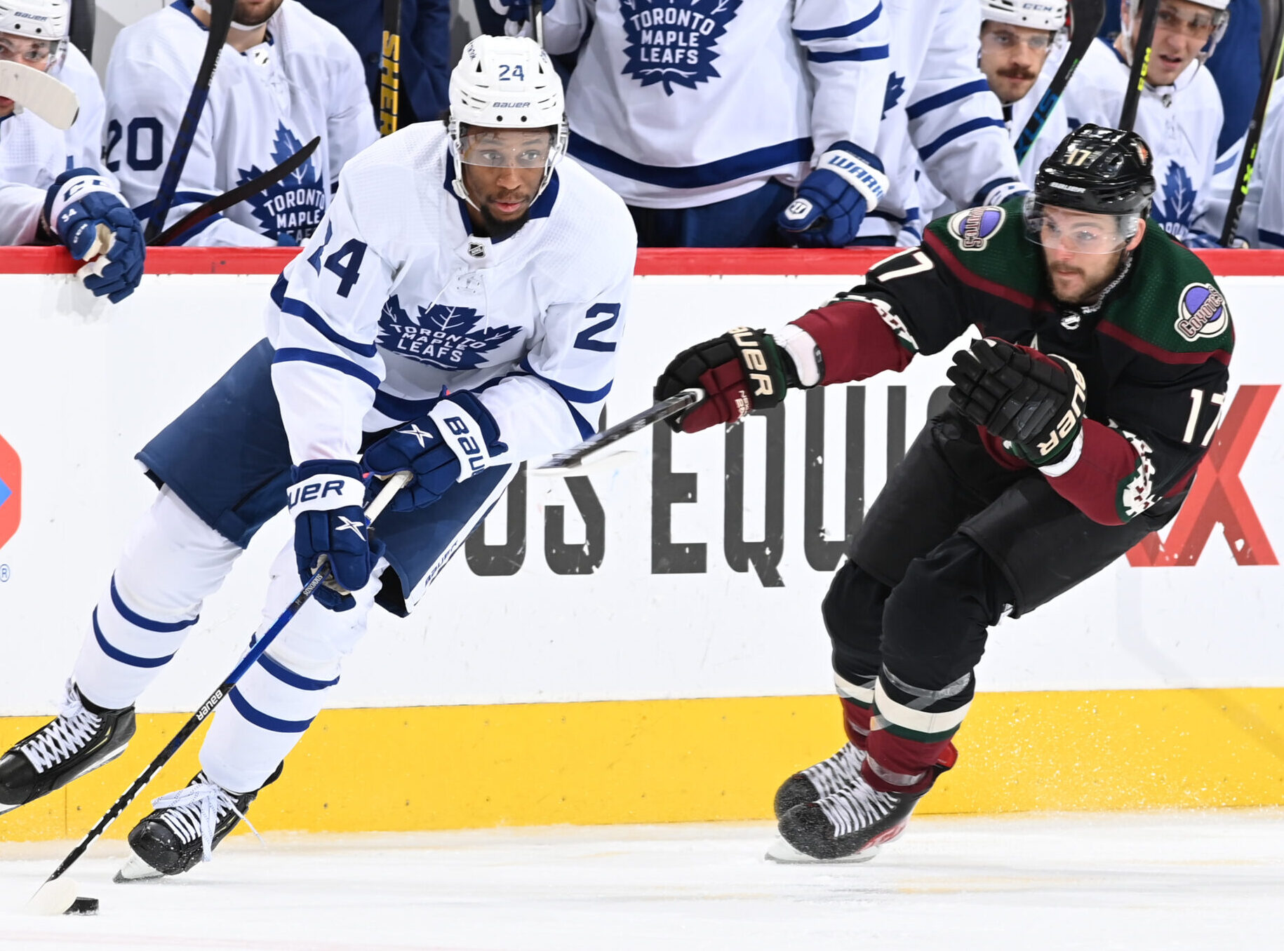 Wayne Simmonds #24 of the Toronto Maple Leafs skates the puck up ice while being defended by Alex Galchenyuk #17 of the Arizona Coyotes at Gila River Arena on January 12, 2022 in Glendale, Arizona.