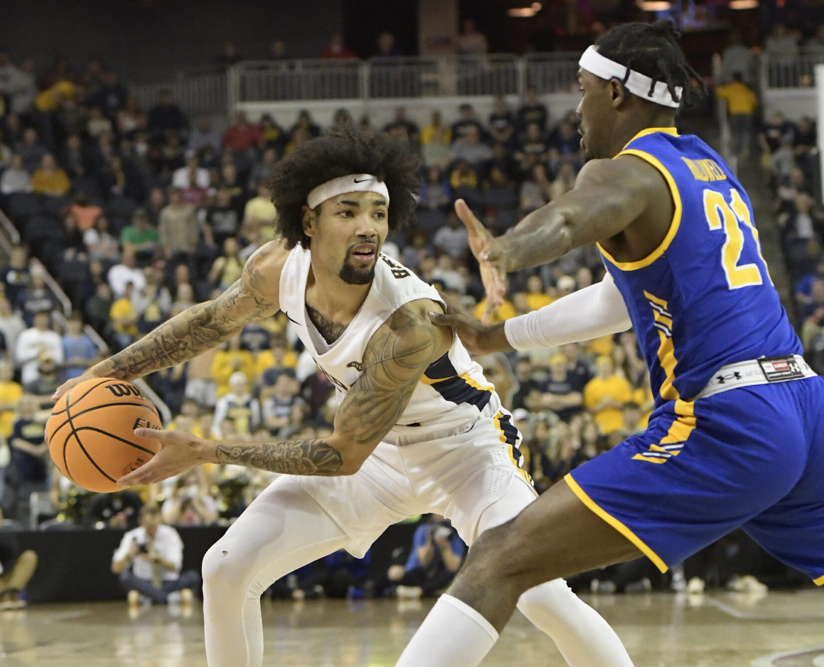 Tevin Brown (10) guard Murray State University Racers looks for a path to advance the basketball past Tray Hollowell (21) guard Morehead State University Eagles during the Ohio Valley Conference (OVC) Tournament Championship, Saturday, March 5, 2022, at Ford Center in Evansville, Indiana.