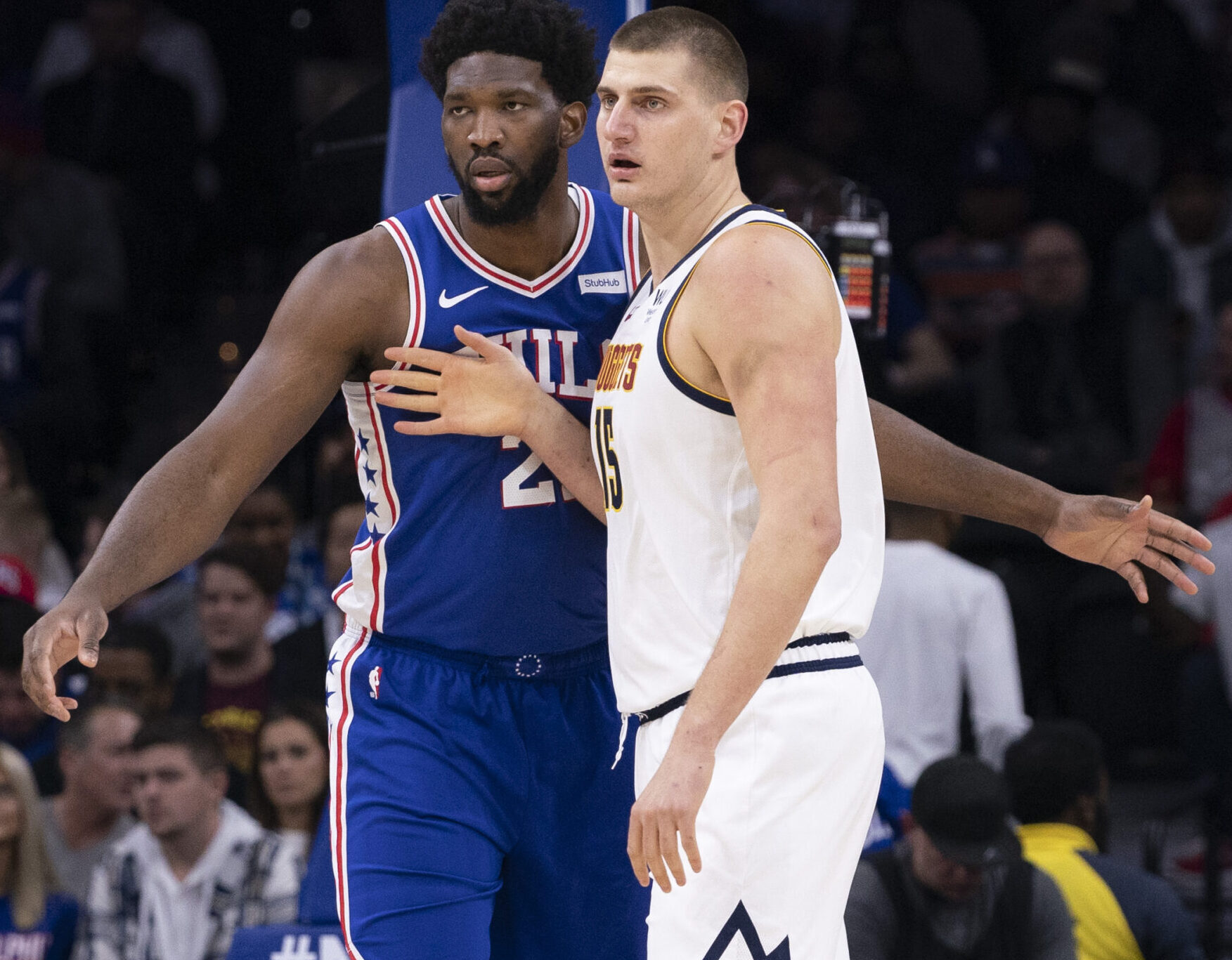 Joel Embiid #21 of the Philadelphia 76ers guards Nikola Jokic #15 of the Denver Nuggets in the first quarter at the Wells Fargo Center on December 10, 2019 in Philadelphia, Pennsylvania.