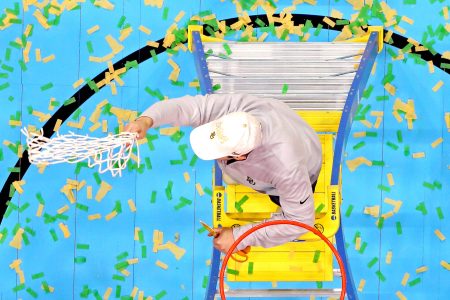 In an overhead shot, Baylor coach Scott Drew (face not seen) waves the basketball net after cutting it off the rim following the Bears' victory over Gonzaga in the 2021 NCAA Tournament men's national championship game at at Lucas Oil Stadium in Indianapolis