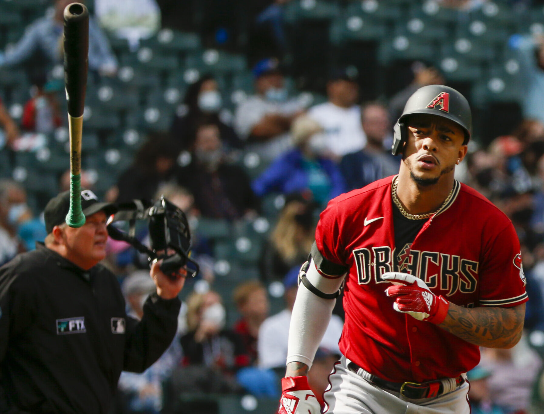Arizona Diamondbacks center fielder Ketel Marte flips his bat after hitting a solo-home run against the Seattle Mariners