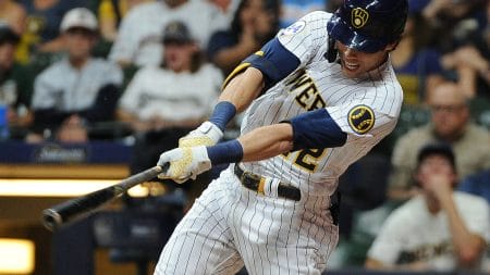 Milwaukee Brewers left fielder Christian Yelich follows throw on a swing and gets a hit against the Chicago Cubs