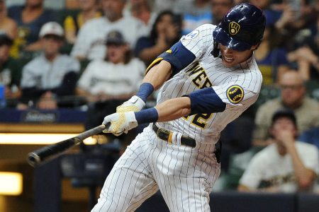 Milwaukee Brewers left fielder Christian Yelich follows throw on a swing and gets a hit against the Chicago Cubs