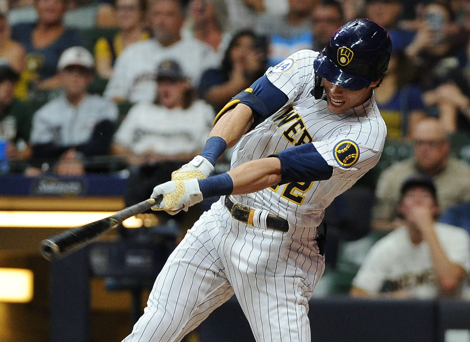 Milwaukee Brewers left fielder Christian Yelich follows throw on a swing and gets a hit against the Chicago Cubs
