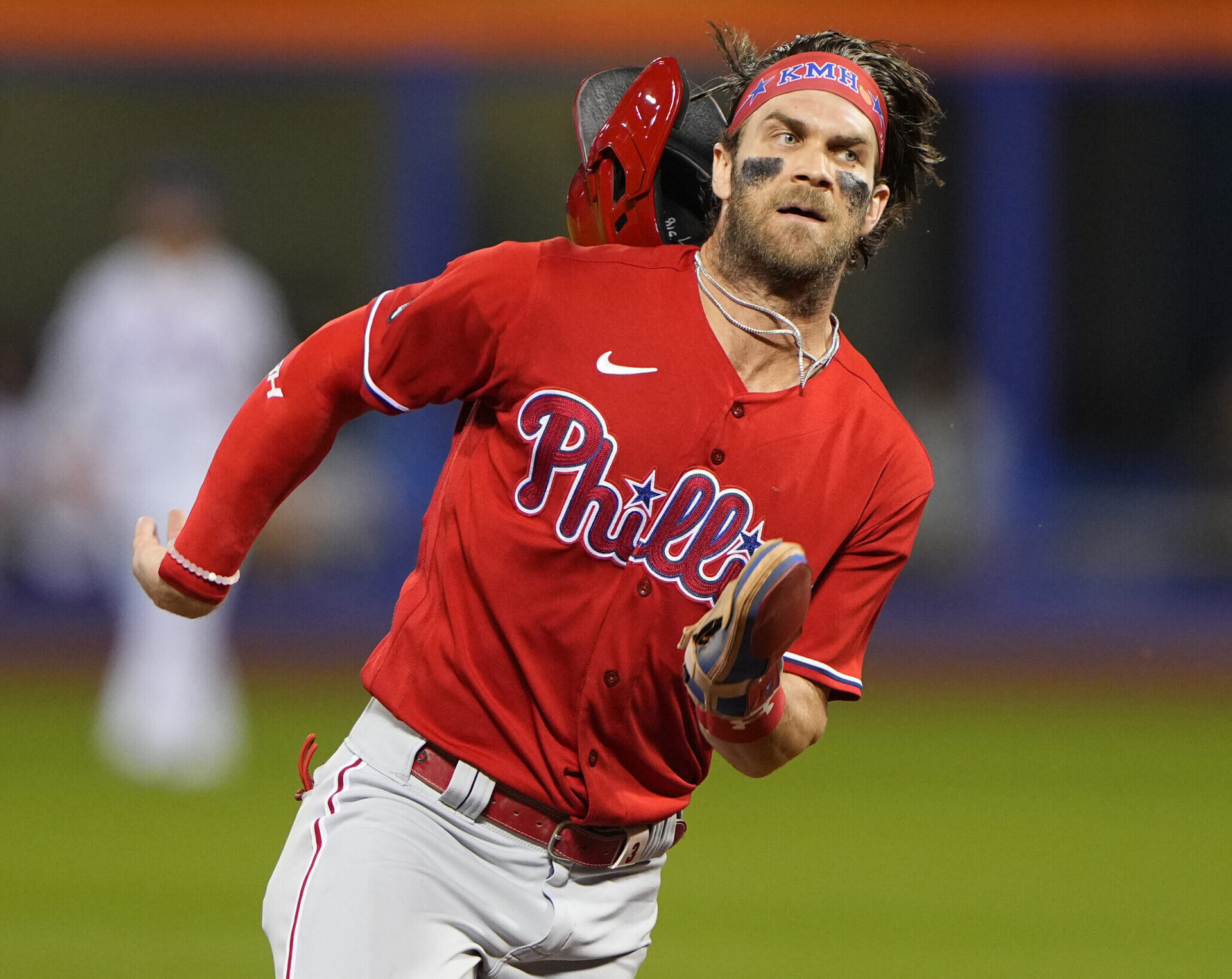 Philadelphia Phillies right fielder Bryce Harper's helmet flies off as he rounds the bases and scores a run against the New York Mets