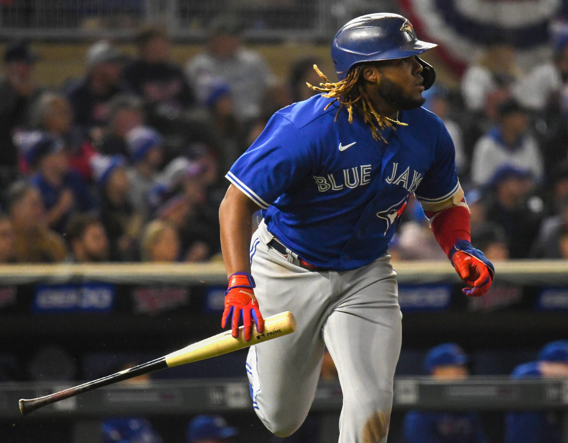 Toronto Blue Jays first baseman Vladimir Guerrero Jr. runs while holding his bat after hitting a fly ball against the Minnesota Twins
