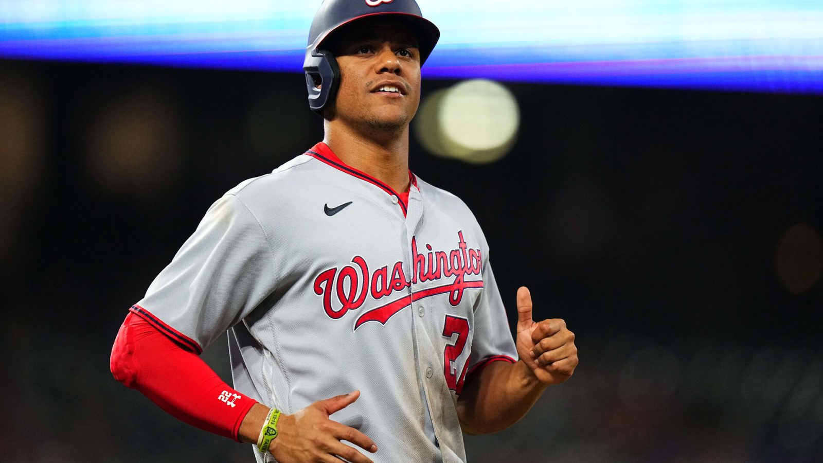 Washington Nationals left fielder Juan Soto jogs to first base with a smile after drawing a walk against the Colorado Rockies