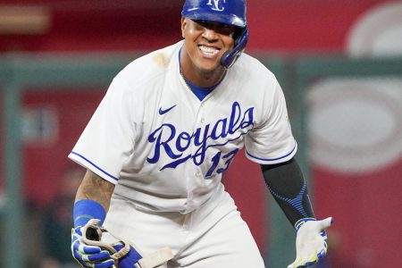 Kansas City Royals catcher Salvador Perez celebrates with his arms outstretched and palms up after hitting a double against the Cleveland Indians