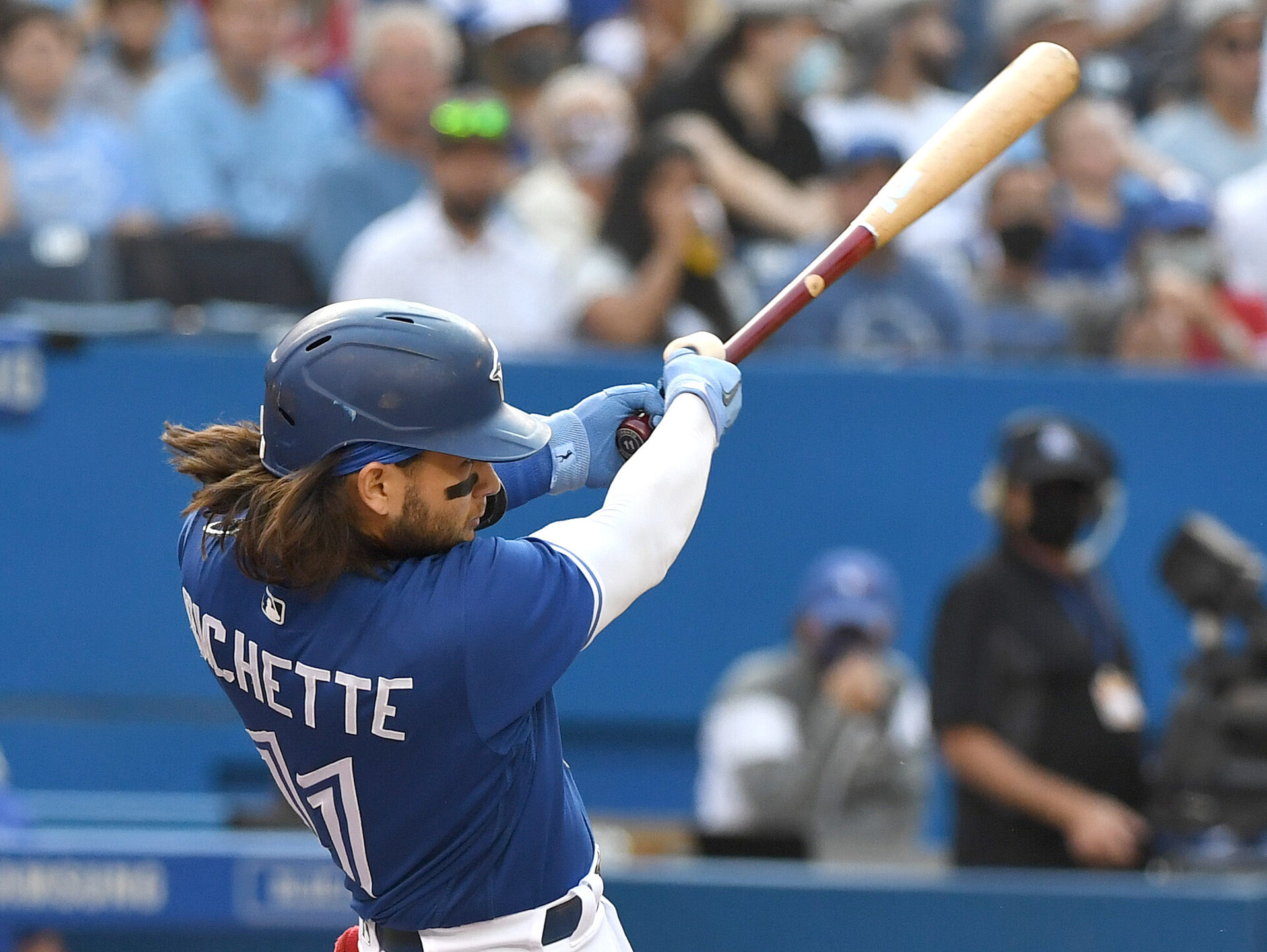 Toronto Blue Jays shortstop Bo Bichette follows through on a swing and hits a solo home run against Baltimore Orioles