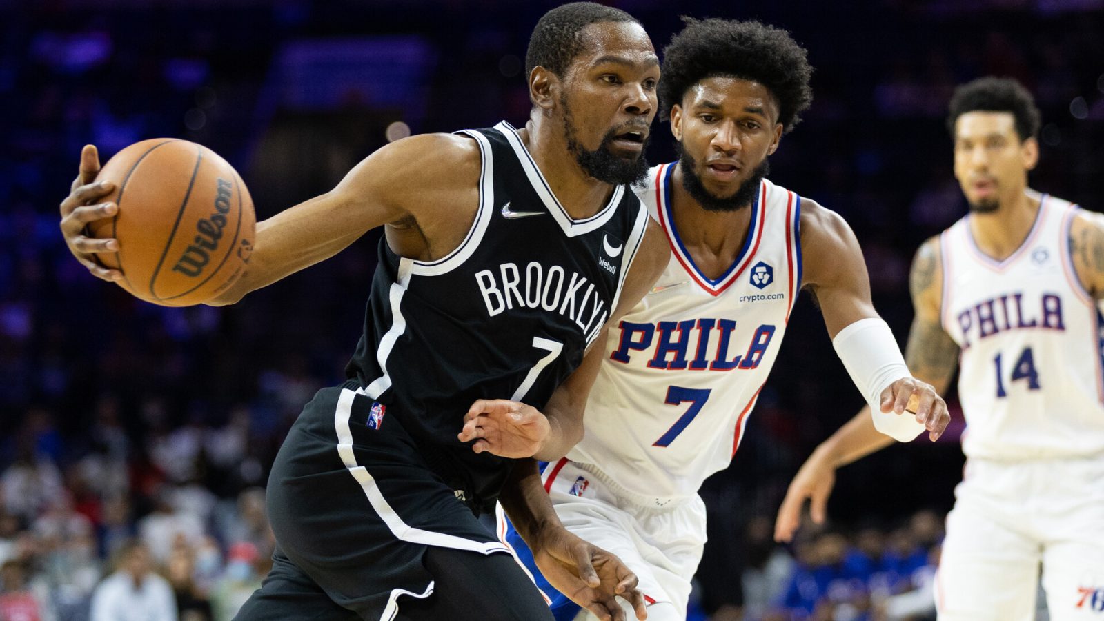Brooklyn Nets forward Kevin Durant (left) drives with the basketball in his left hand against Philadelphia 76ers guard Isaiah Joe (right)
