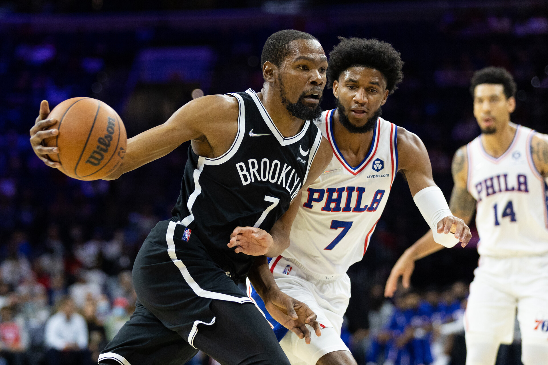 Brooklyn Nets forward Kevin Durant (left) drives with the basketball in his left hand against Philadelphia 76ers guard Isaiah Joe (right)