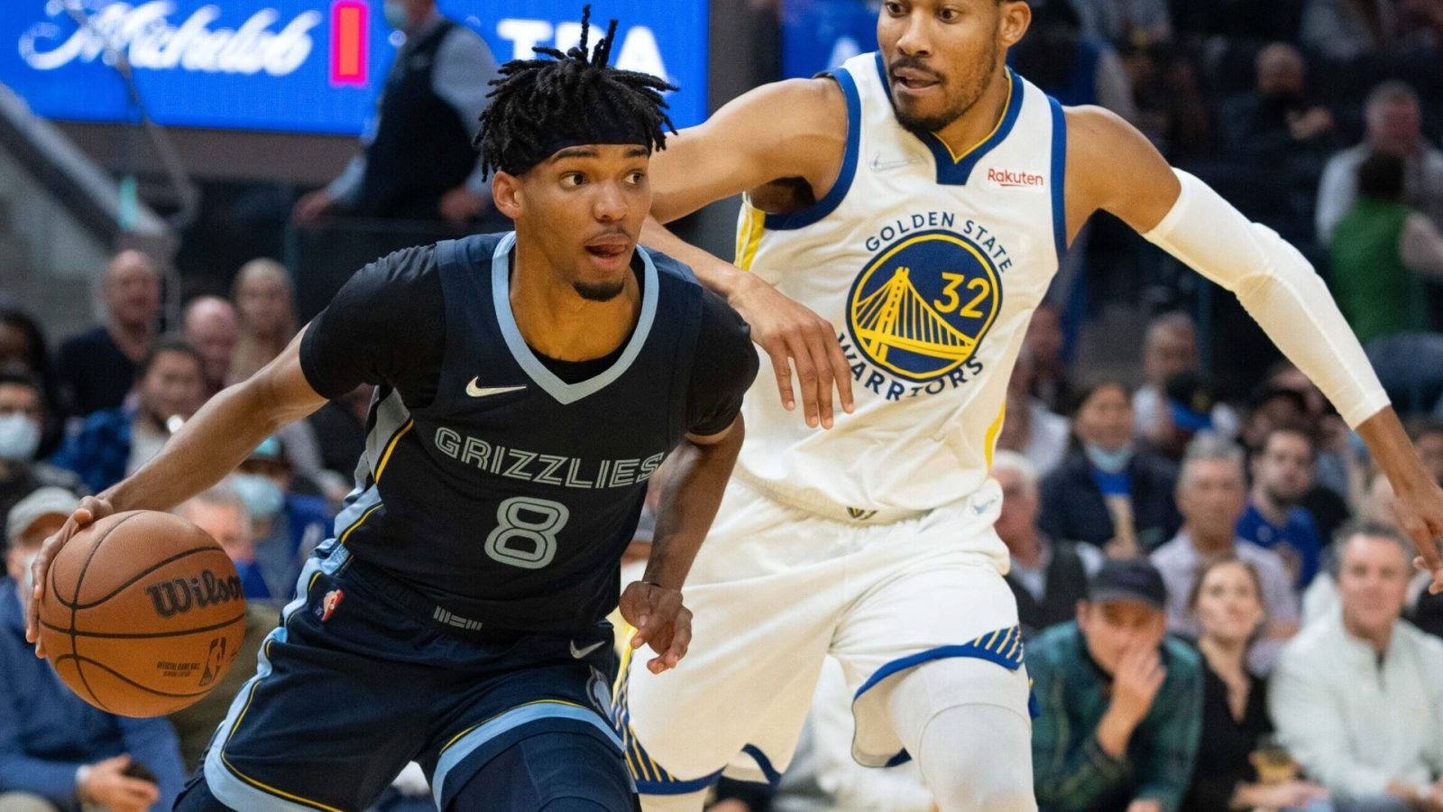 Memphis Grizzlies guard Ziaire Williams (left) dribbles the basketball with his right hand while attempting to make a move around defending Golden State Warriors forward Otto Porter Jr. (right)