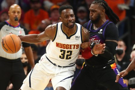 Denver Nuggets forward Jeff Green (left) dribbles the basketball with his right hand as he leans into defending Phoenix Suns forward Jae Crowder (right)