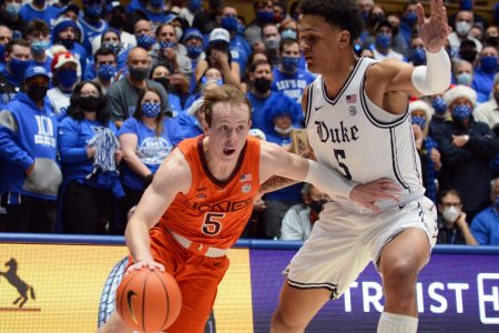 Virginia Tech Hokies guard Storm Murphy (left) dribbles the basketball with his right hand and drives to the basket as Duke Blue Devils forward Paolo Banchero (left) defends during an ACC basketball game