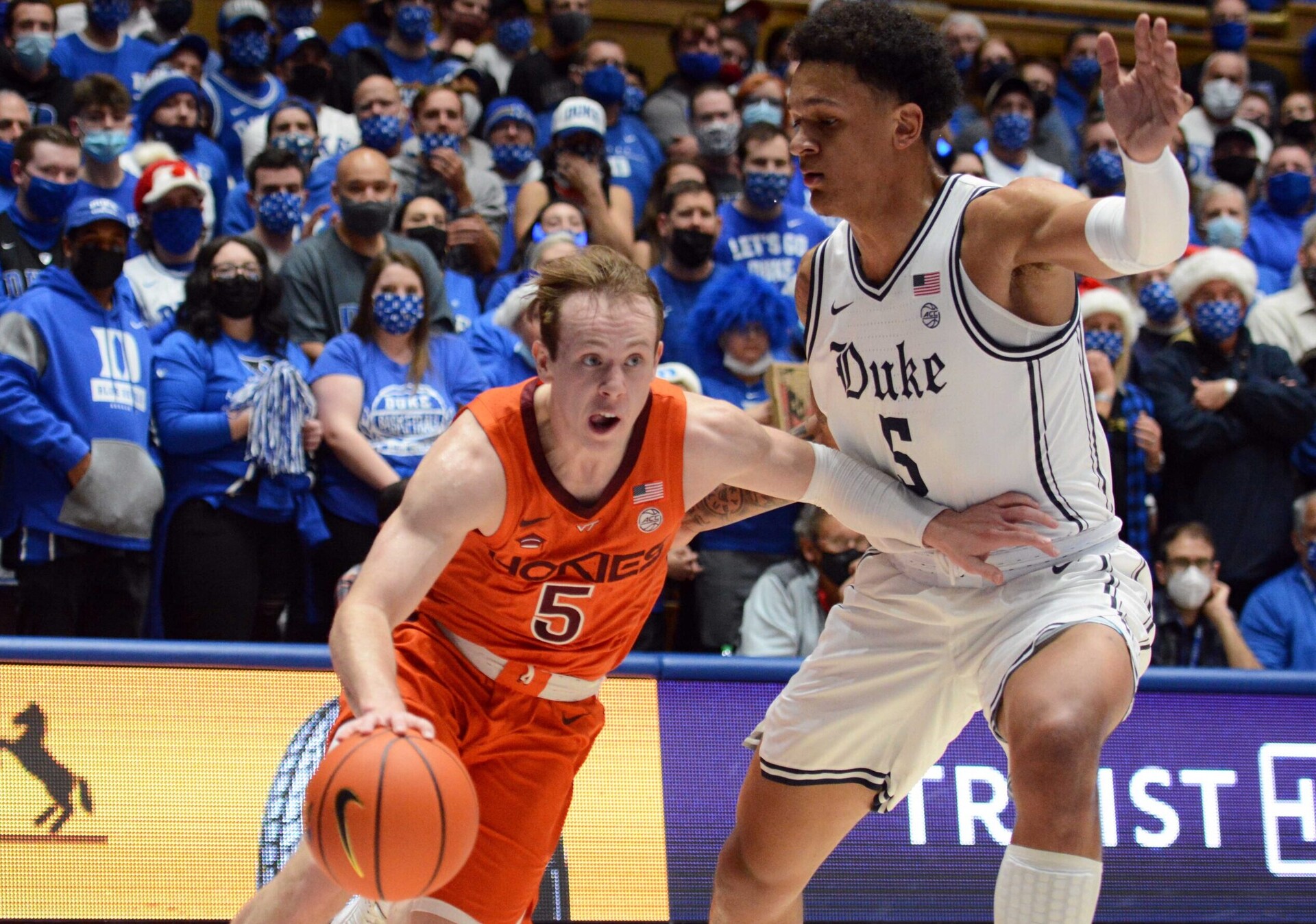 Virginia Tech Hokies guard Storm Murphy (left) dribbles the basketball with his right hand and drives to the basket as Duke Blue Devils forward Paolo Banchero (left) defends during an ACC basketball game