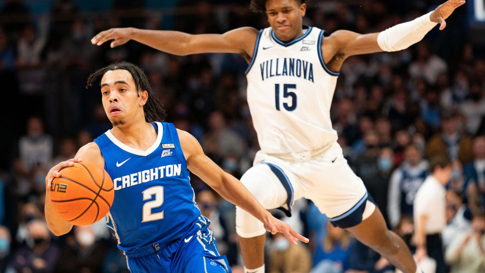 Creighton Bluejays guard Ryan Nembhard (right) dribbles the ball with his right hand and gets past Villanova Wildcats guard Jordan Longino (right) during a Big East basketball game