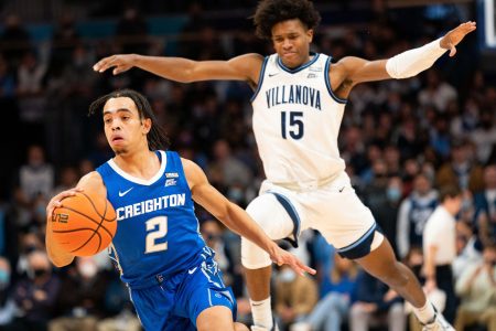 Creighton Bluejays guard Ryan Nembhard (right) dribbles the ball with his right hand and gets past Villanova Wildcats guard Jordan Longino (right) during a Big East basketball game