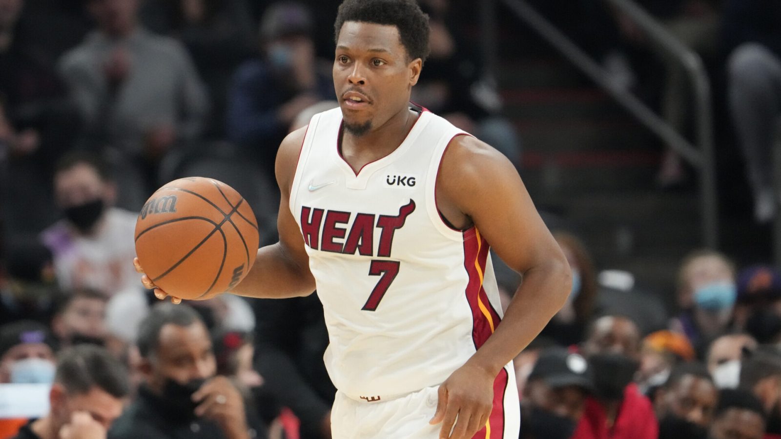Miami Heat guard Kyle Lowry (7) dribbles the ball with his right hand as he heads down the court in a game against the Phoenix Suns