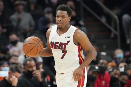 Miami Heat guard Kyle Lowry (7) dribbles the ball with his right hand as he heads down the court in a game against the Phoenix Suns