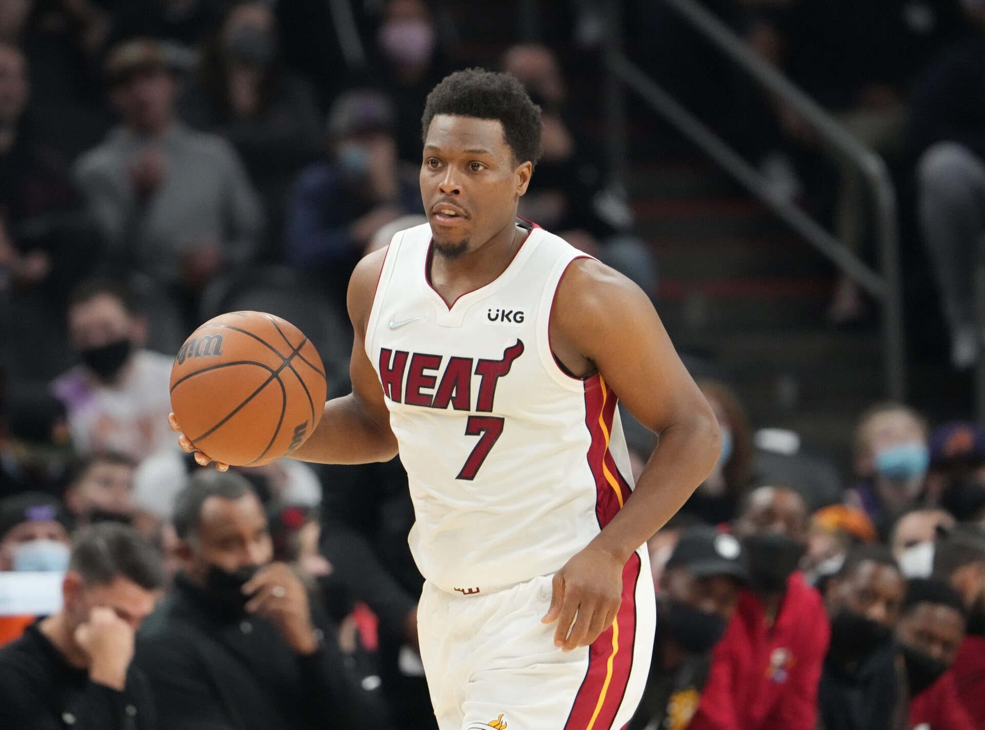Miami Heat guard Kyle Lowry (7) dribbles the ball with his right hand as he heads down the court in a game against the Phoenix Suns