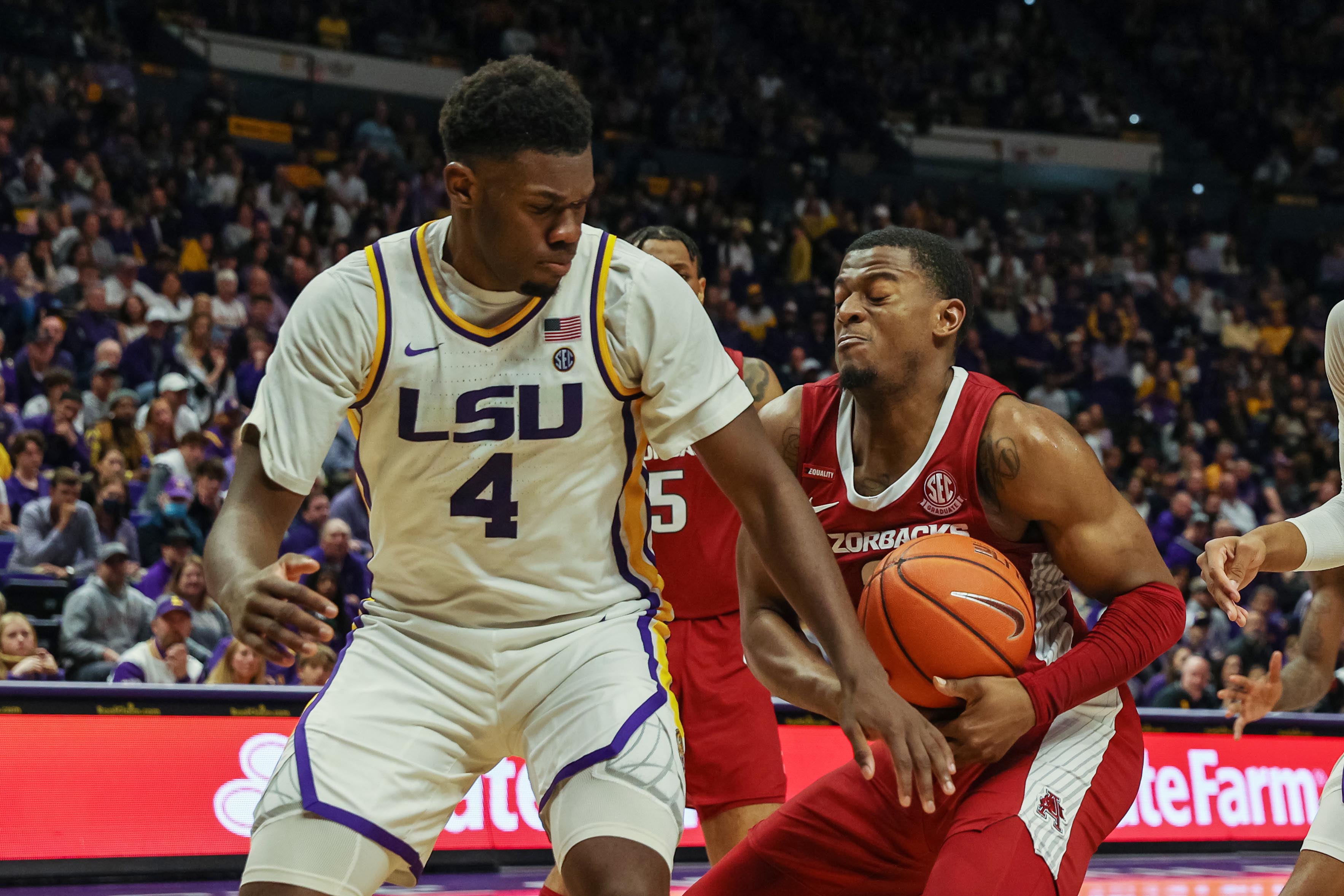 Arkansas Razorbacks guard Au'Diese Toney (right) dribbles against LSU Tigers forward Darius Days (left) during an SEC basketball game