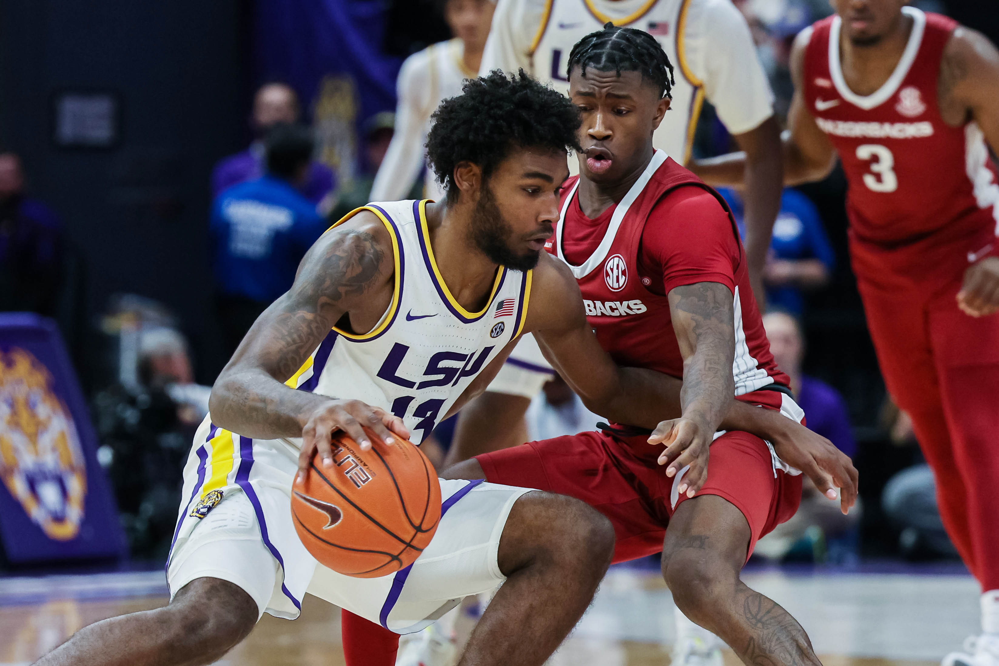 LSU Tigers forward Tari Eason (left) dribbles against Arkansas Razorbacks guard Davonte Davis (right) during an SEC basketball game