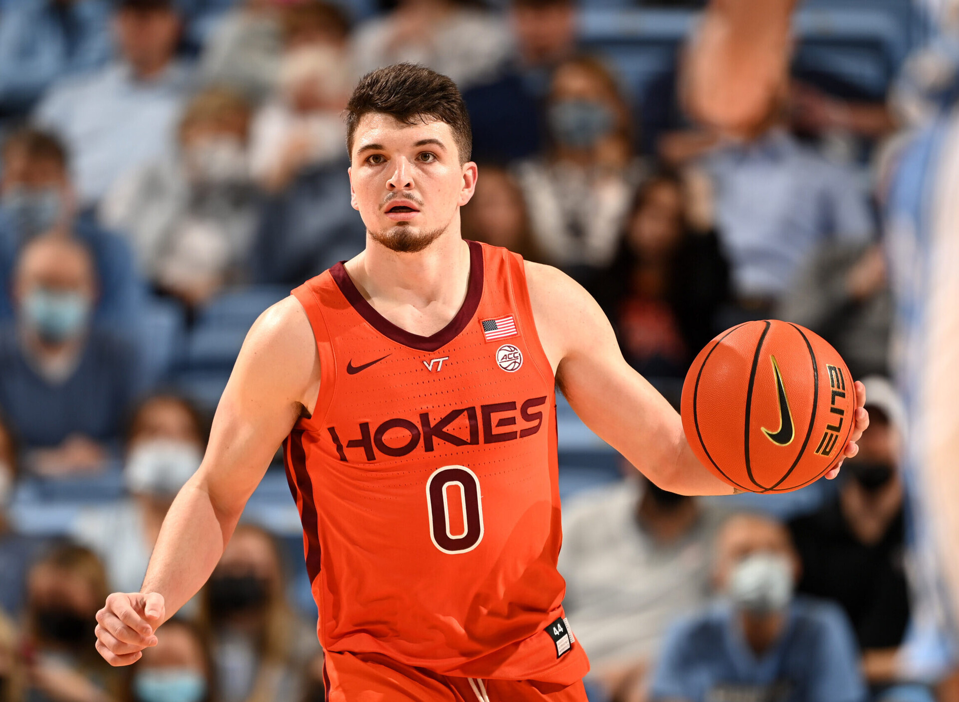 Virginia Tech Hokies guard Hunter Cattoor dribbles the ball up the court with his left hand during an ACC basketball game against North Carolina