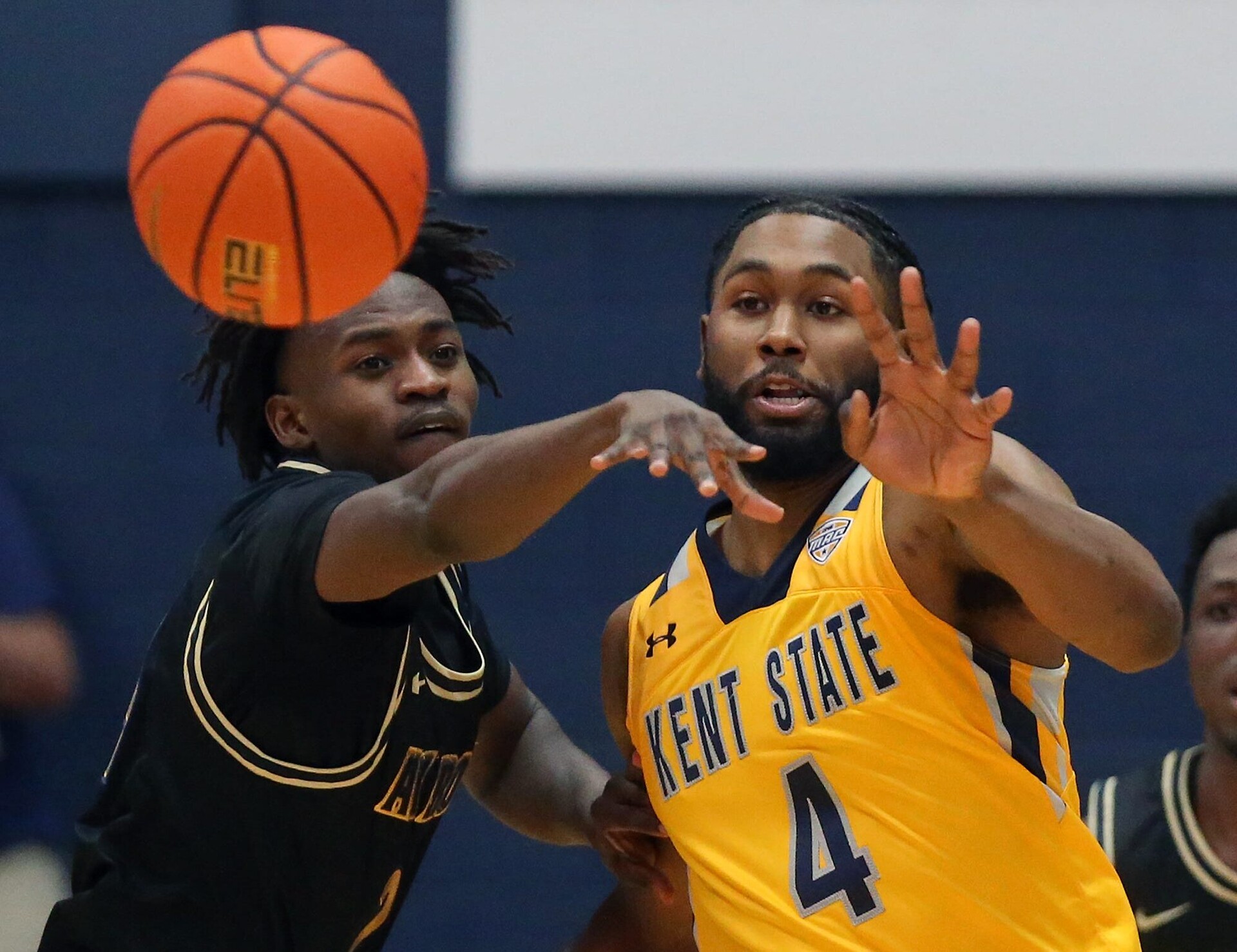 Akron Zips forward Ali Ali (left) and Kent State Golden Flashes guard Andrew Garcia (right) reach for a loose ball