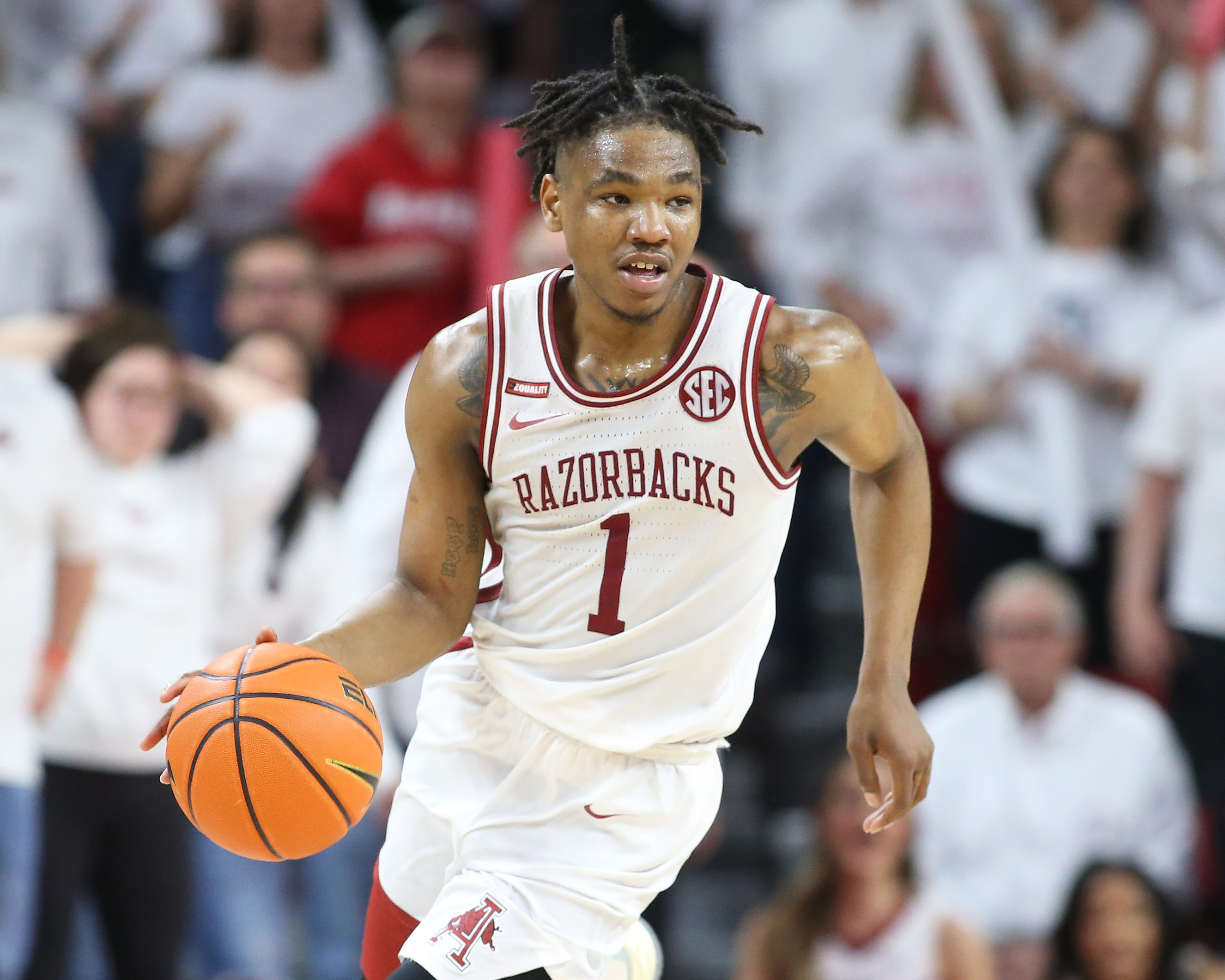 Arkansas Razorbacks guard JD Notae dribbles the ball during an SEC basketball game against the Auburn Tigers