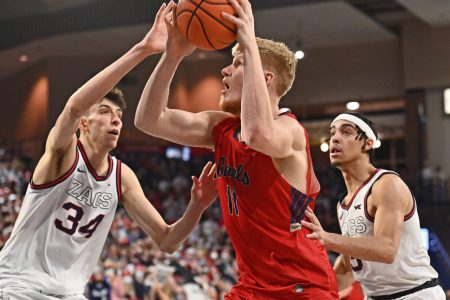 St. Mary's Gaels forward Matthias Tass (center) shoots the ball with his right hand against Gonzaga Bulldogs center Chet Holmgren (left) during a West Coast Conference basketball game