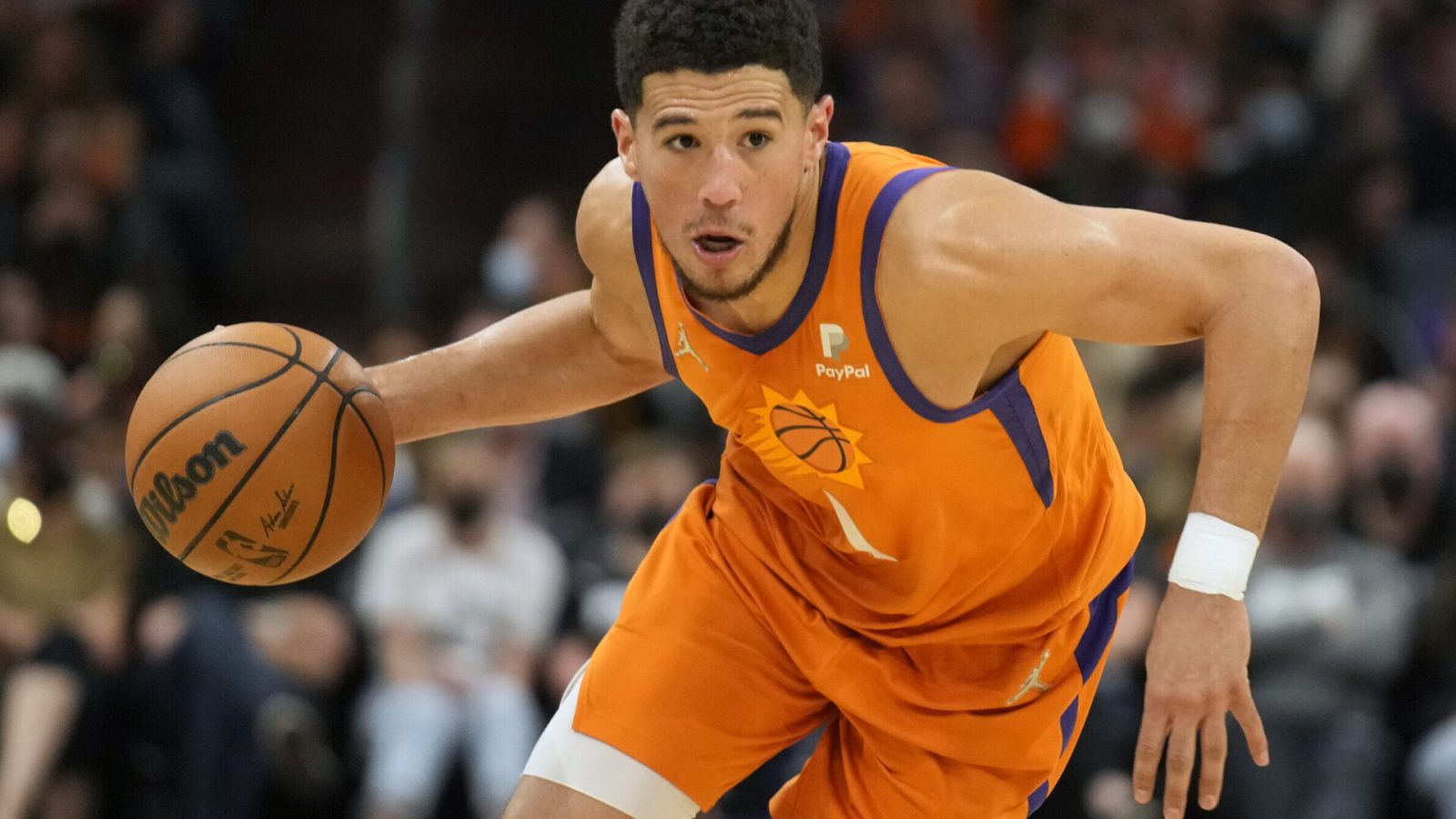 Phoenix Suns guard Devin Booker dribbles the basketball with his right hand as he looks to drive to the hoop against the New Orleans Pelicans