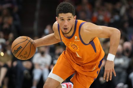 Phoenix Suns guard Devin Booker dribbles the basketball with his right hand as he looks to drive to the hoop against the New Orleans Pelicans