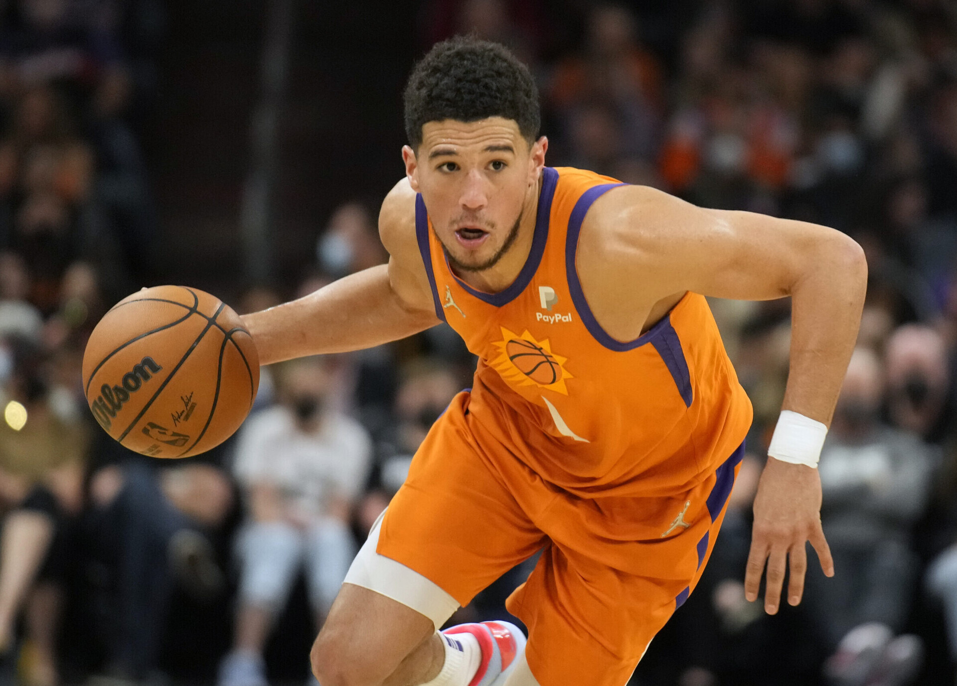 Phoenix Suns guard Devin Booker dribbles the basketball with his right hand as he looks to drive to the hoop against the New Orleans Pelicans