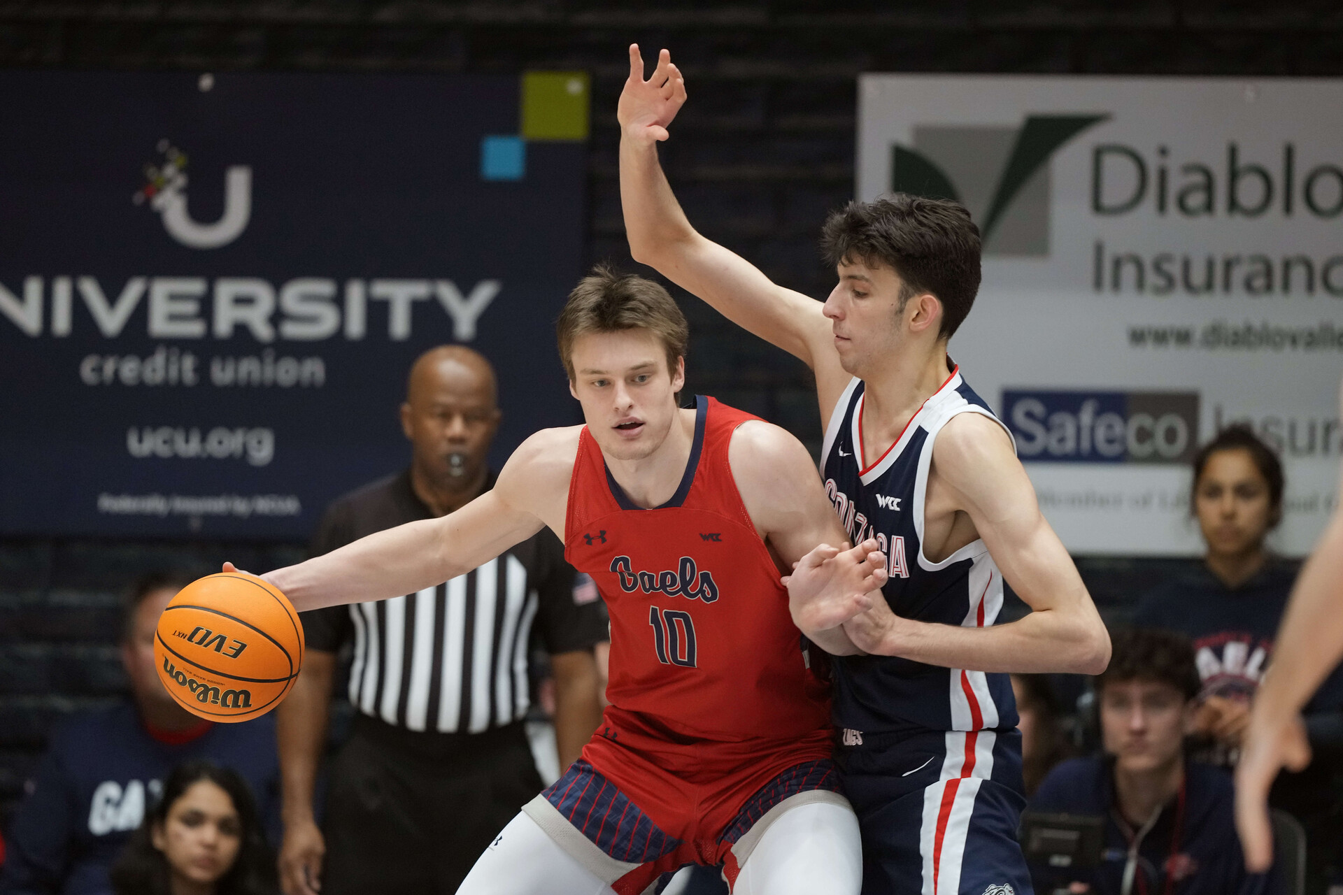 Feb 26, 2022; Moraga, California, USA; Saint Mary's Gaels center Mitchell Saxen (10) handles the ball while being defended by Gonzaga Bulldogs center Chet Holmgren (34) during the first half at University Credit Union Pavilion.