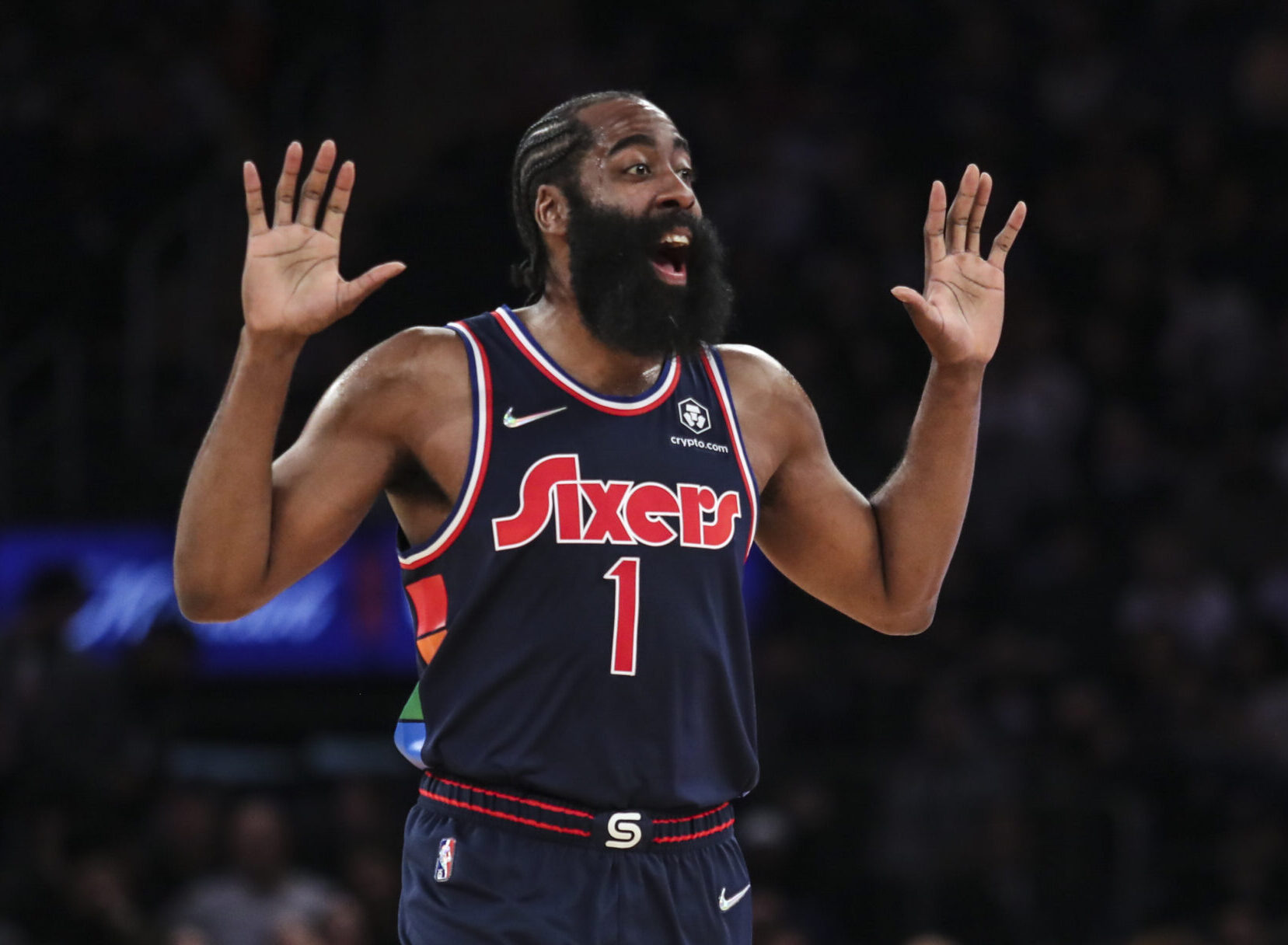 Philadelphia 76ers guard James Harden raises both arms as he yells out to his teammates in the first quarter against the New York Knicks