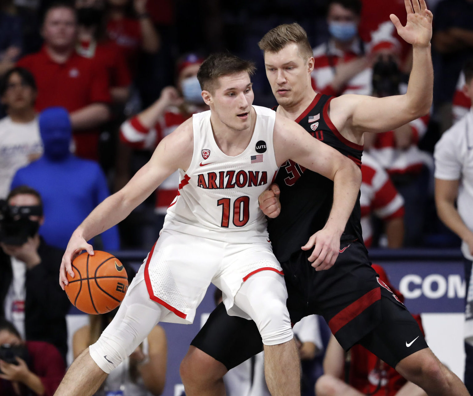 Stanford Cardinal forward Lukas Kisunas (32) defends Arizona Wildcats forward Azuolas Tubelis (10) during the first half in Tucson, Ariz.