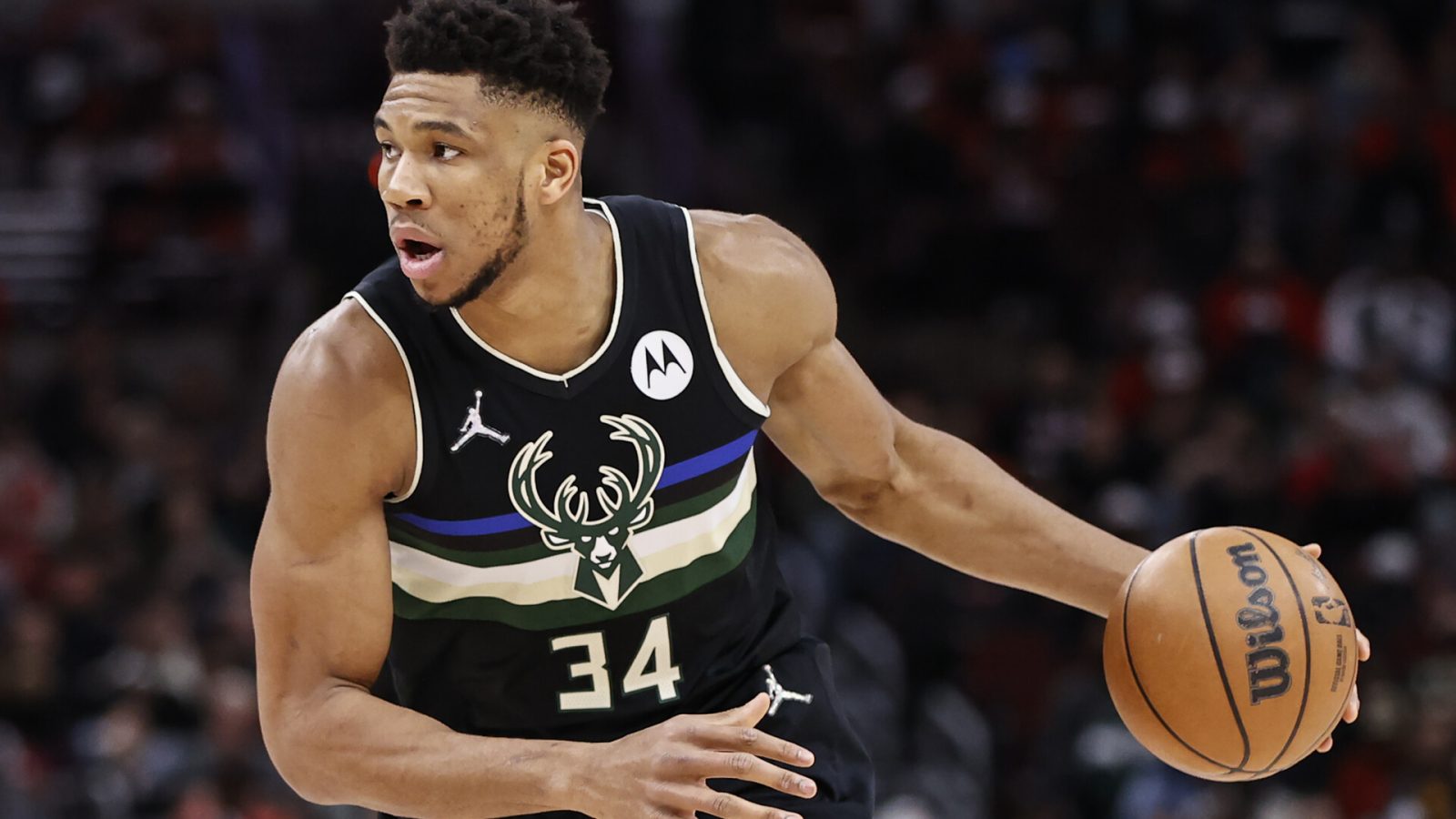 Milwaukee Bucks forward Giannis Antetokounmpo dribbles the ball down the court with his left hand during a game against the Chicago Bulls
