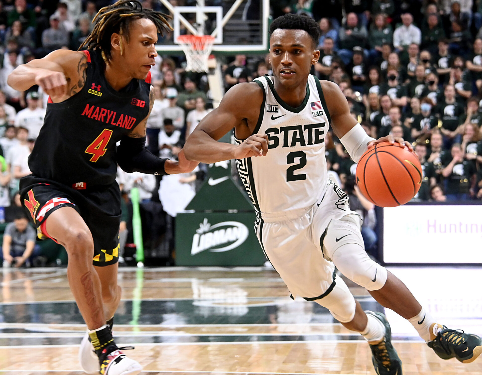 Michigan State Spartans guard Tyson Walker (right) dribbles the ball with his left hand as he drives past defending Maryland Terrapins guard Fatts Russell (left) during a Big Ten basketball game