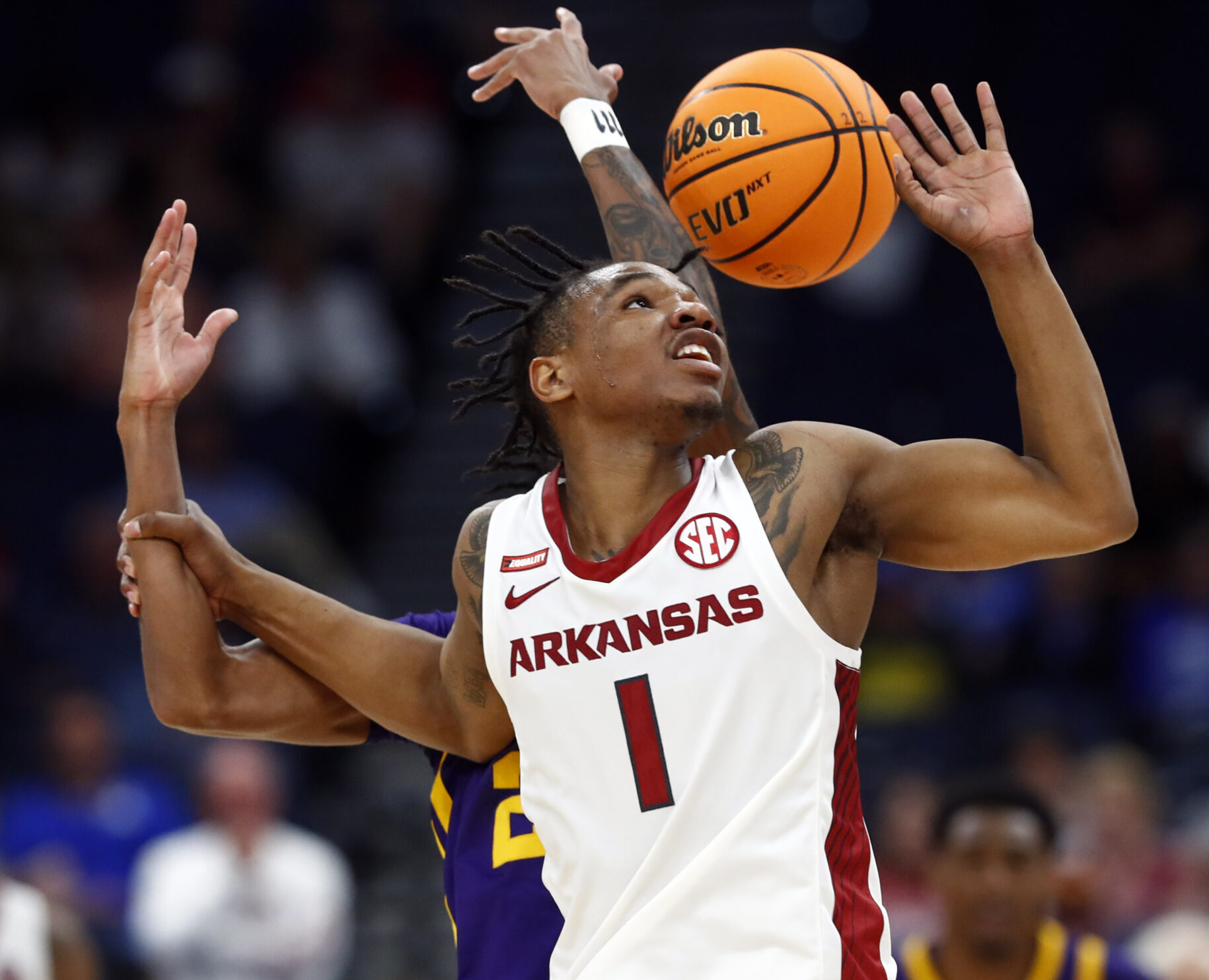 Arkansas Razorbacks guard JD Notae (1) and LSU Tigers guard Eric Gaines (2) fight to control the ball during the second half at Amalie Arena in Tampa, Fla., on March 11, 2022.