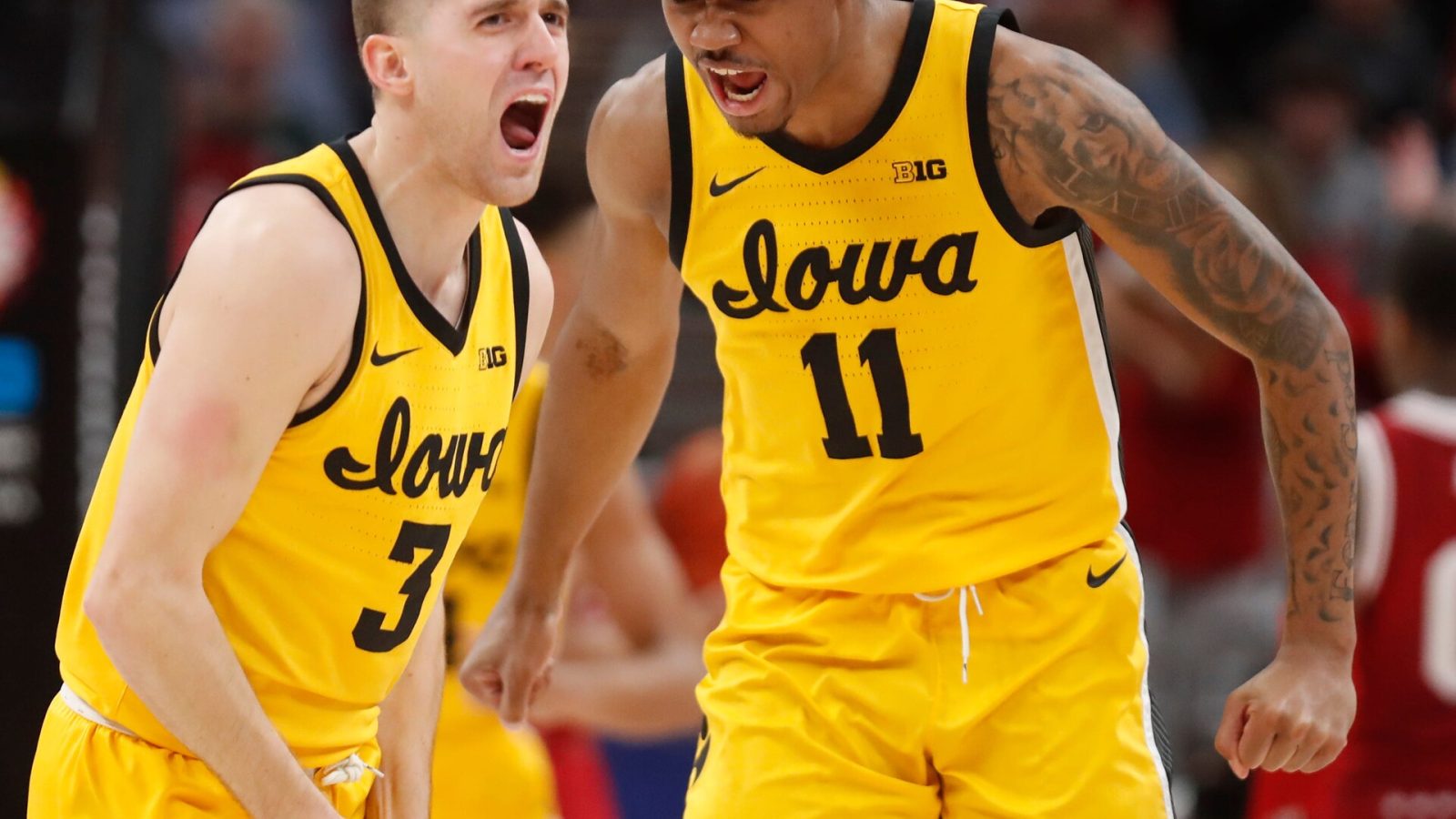 Iowa Hawkeyes guard Jordan Bohannon (3) and Iowa Hawkeyes guard Tony Perkins (11) celebrate during the men’s Big Ten tournament game against the Indiana Hoosiers, Saturday, March 12, 2022, at Gainbridge Fieldhouse in Indianapolis. The Hawkeyes won 80-77.