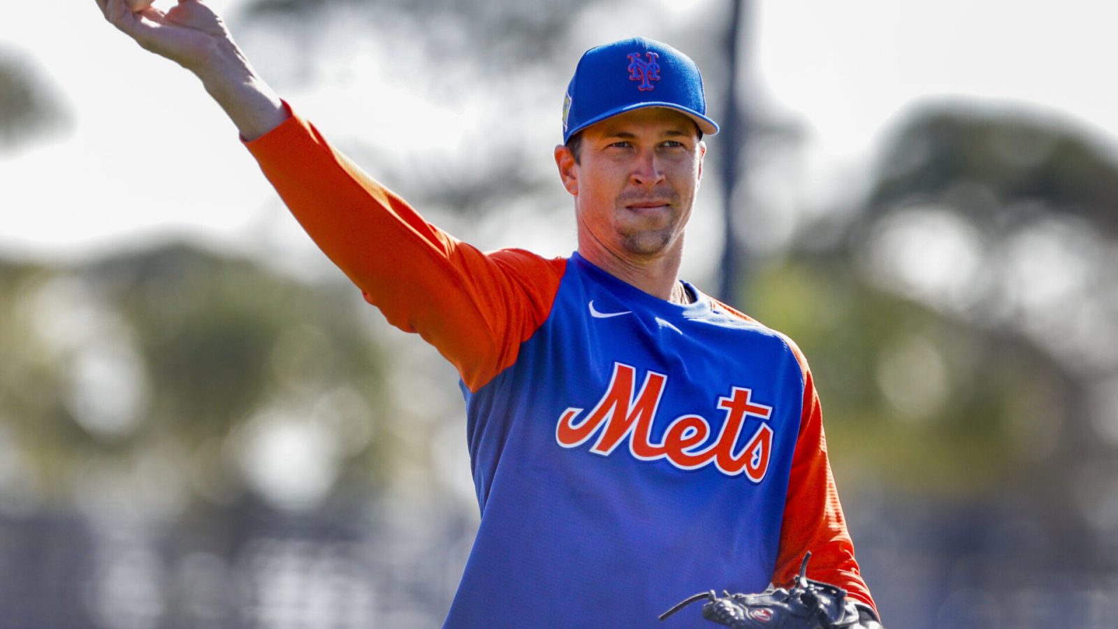 New York Mets right-handed starting pitcher Jacob deGrom casually tosses a baseball during spring training warmups