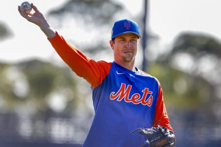 New York Mets right-handed starting pitcher Jacob deGrom casually tosses a baseball during spring training warmups