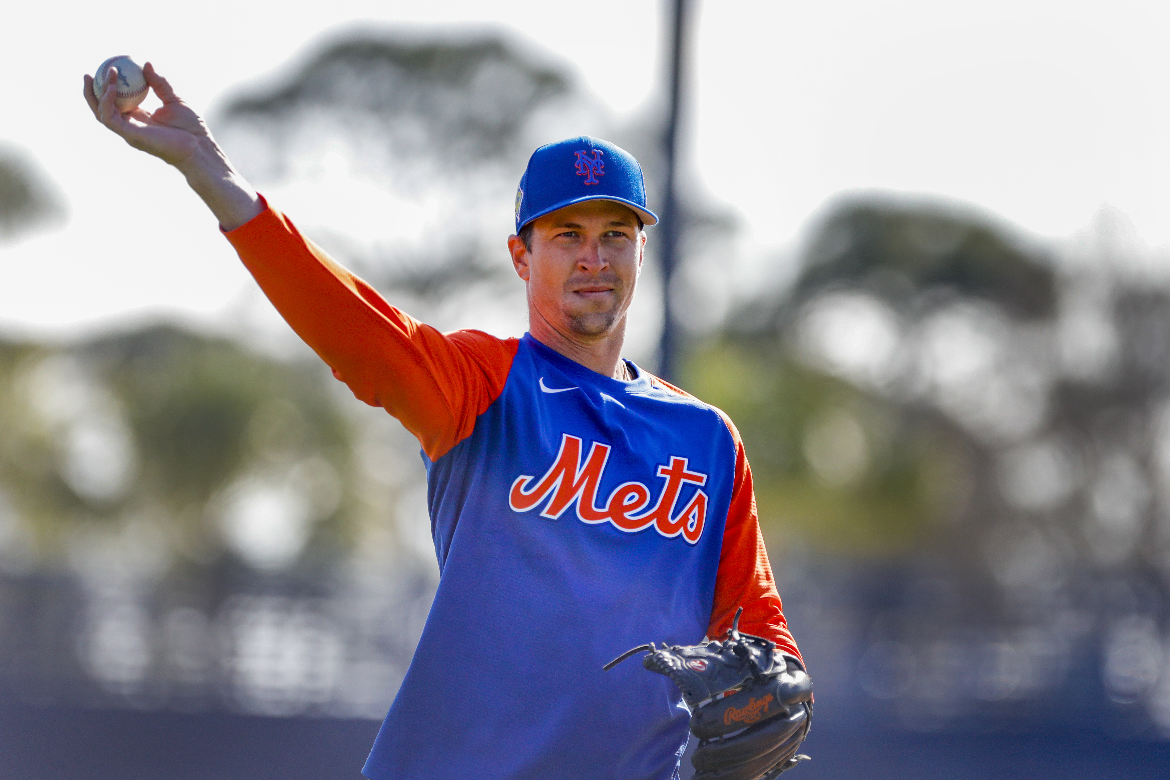 New York Mets right-handed starting pitcher Jacob deGrom casually tosses a baseball during spring training warmups