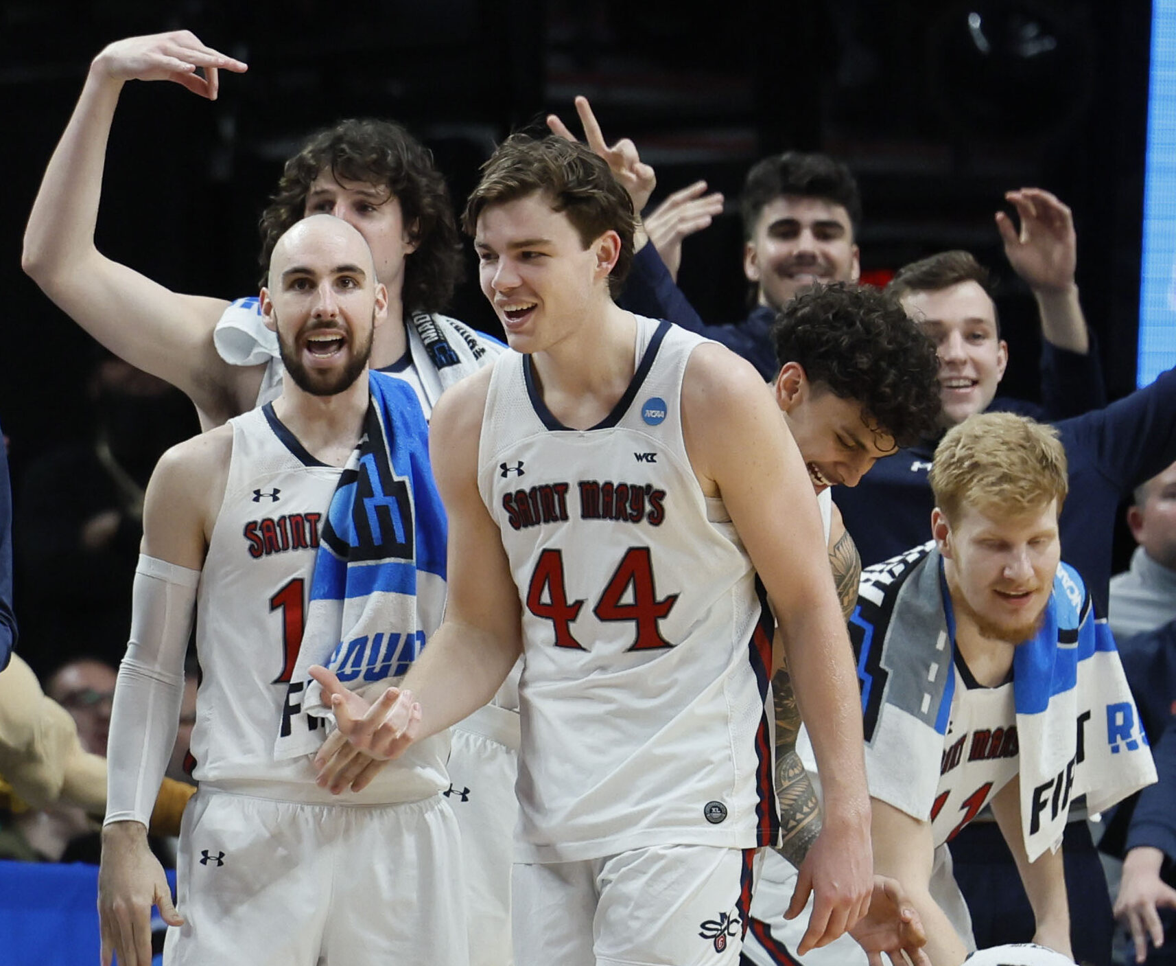 Saint Mary's Gaels guards Tommy Kuhse (left) and guard Alex Ducas (center) celebrate against the Indiana Hoosiers during the second half during the first round of the 2022 NCAA Tournament